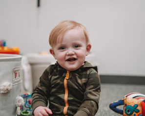 A joyful child playing with colorful toys from our catalog in a bright, cheerful playroom