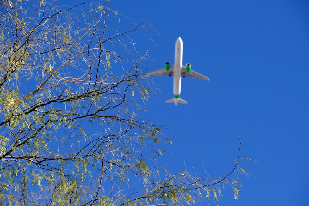an airplane is flying in the blue sky,