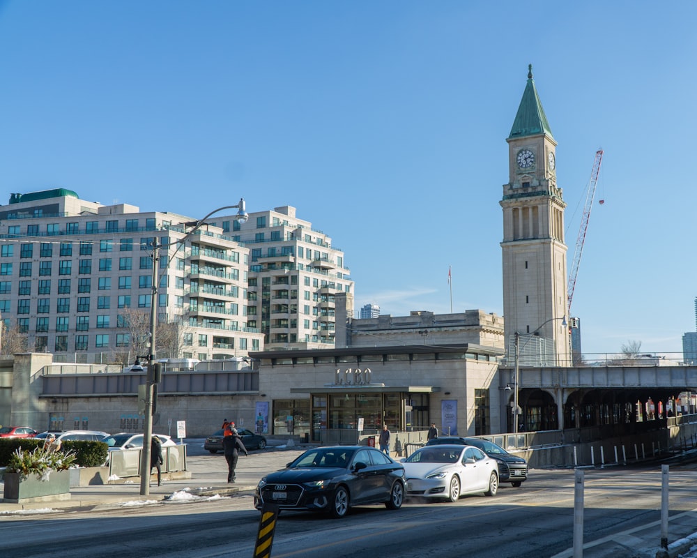 a city street with a clock tower in the background