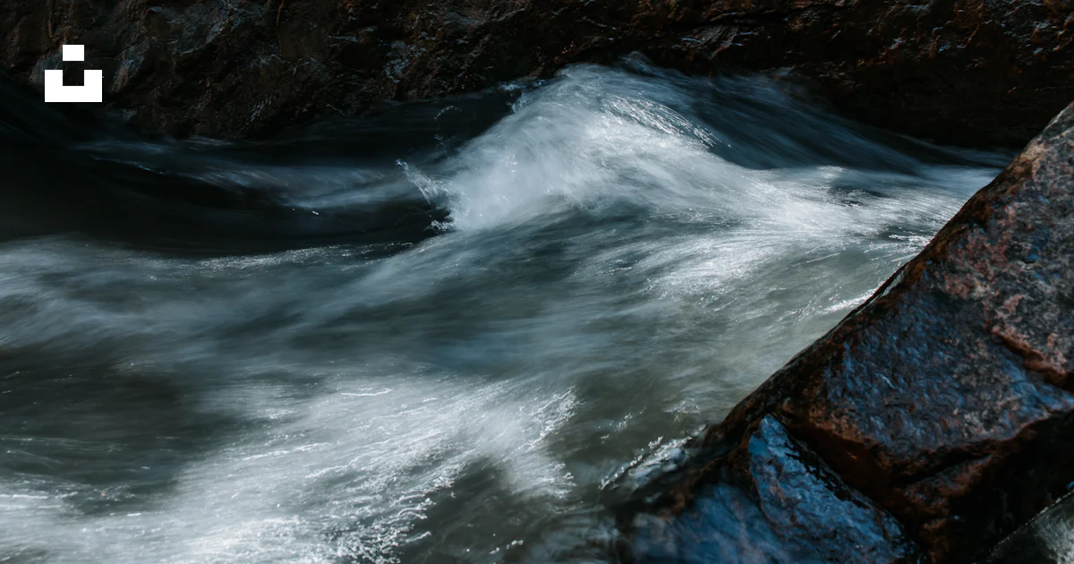 The water is rushing over the rocks in the river photo – Free Nature ...