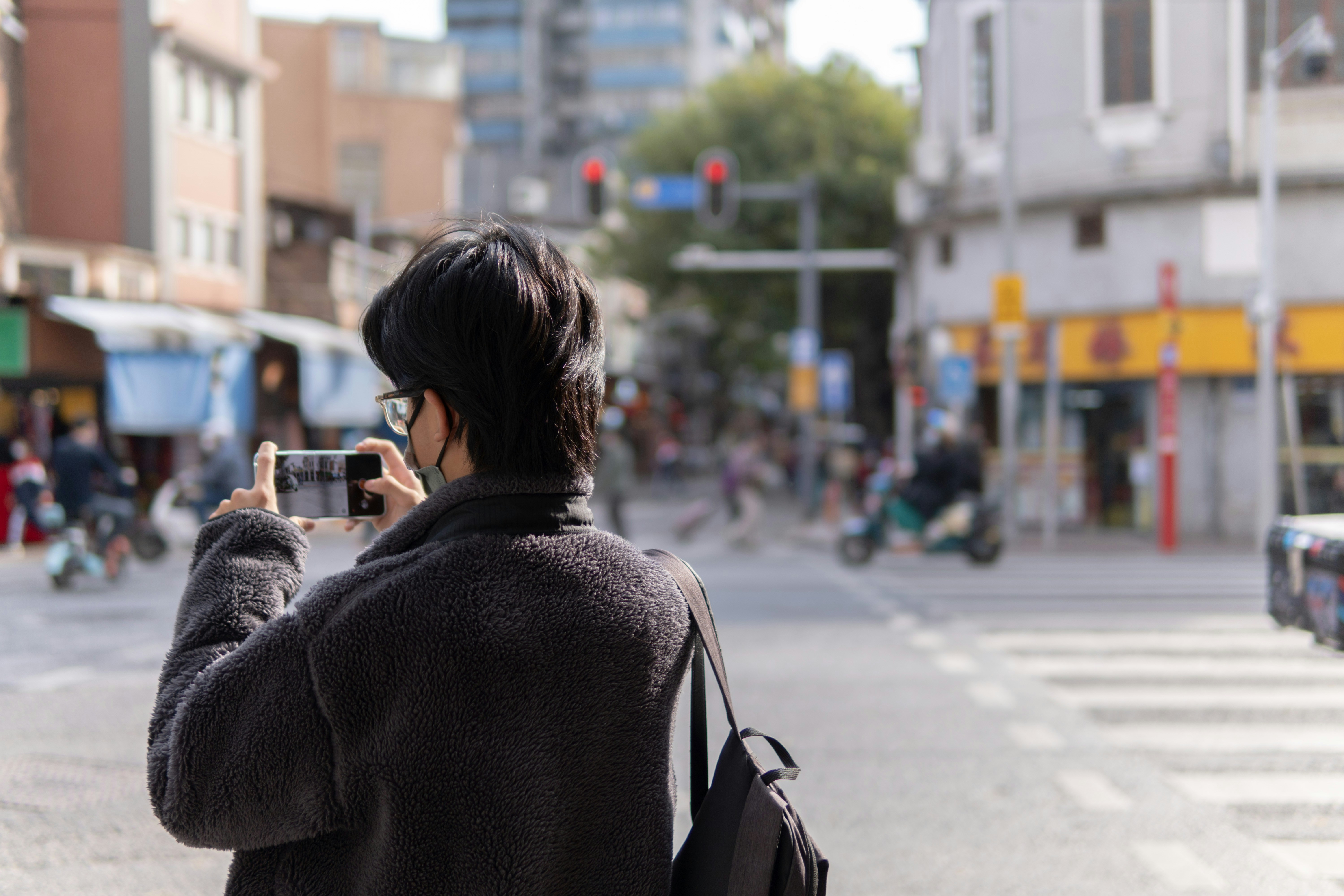 a woman is taking a picture of herself on the street