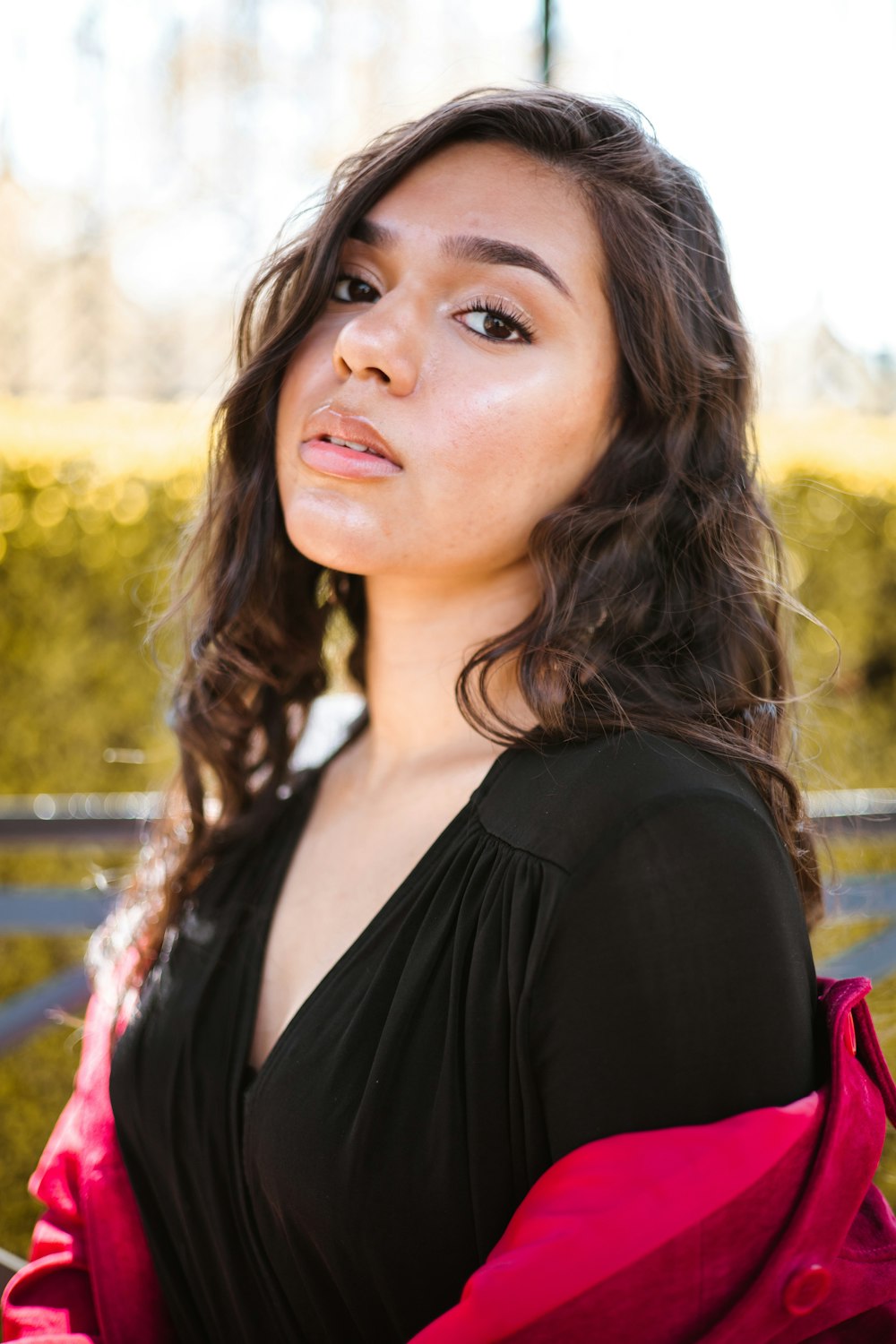 a woman in a black and pink dress posing for a picture