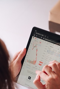 a woman holding a tablet with a chart on it