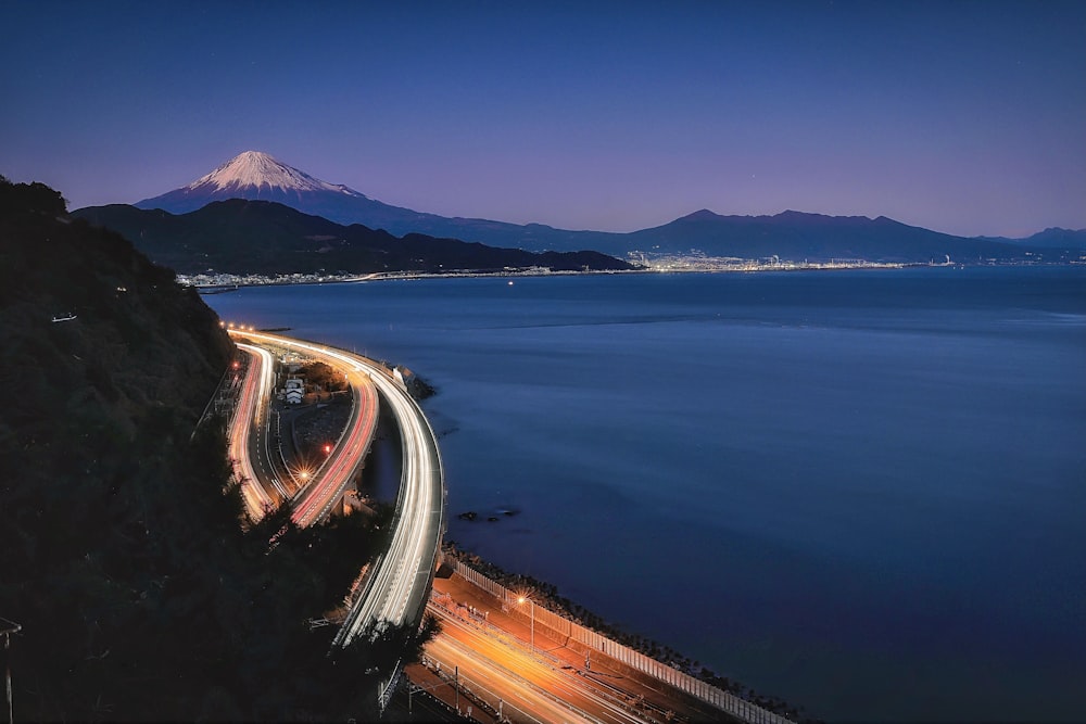 a long exposure shot of a highway going over a body of water