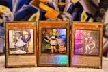 Three Yu-Gi-Oh! trading cards are displayed on a surface. Each card features a character themed as a 'Dragonmaid' with vivid colors and detailed artwork. The cards are titled 'Laundry Dragonmaid', 'Parlor Dragonmaid', and 'Nurse Dragonmaid'. The background has a colorful and abstract design, adding a fantastical atmosphere.