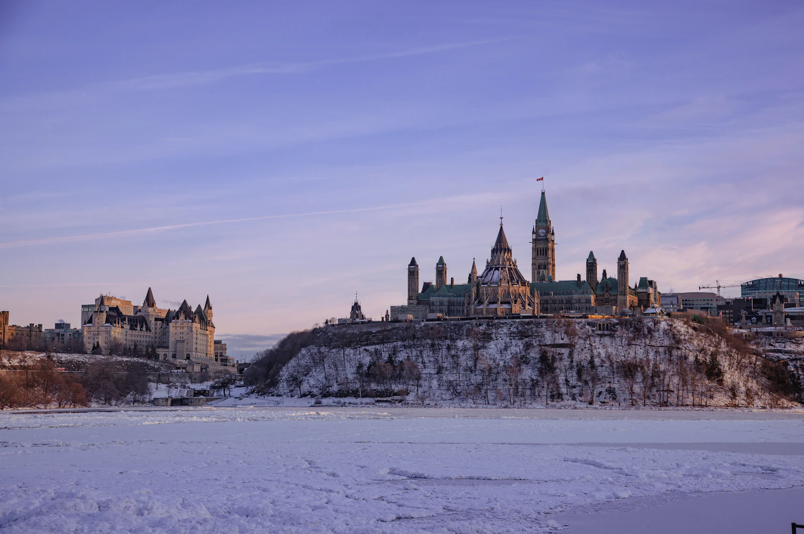 Parliament Hill and the frozen Ottawa River on a winter evening