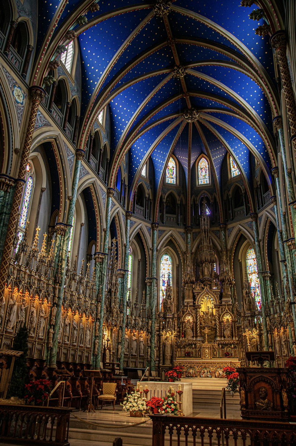 a large cathedral with a blue ceiling and stained glass windows