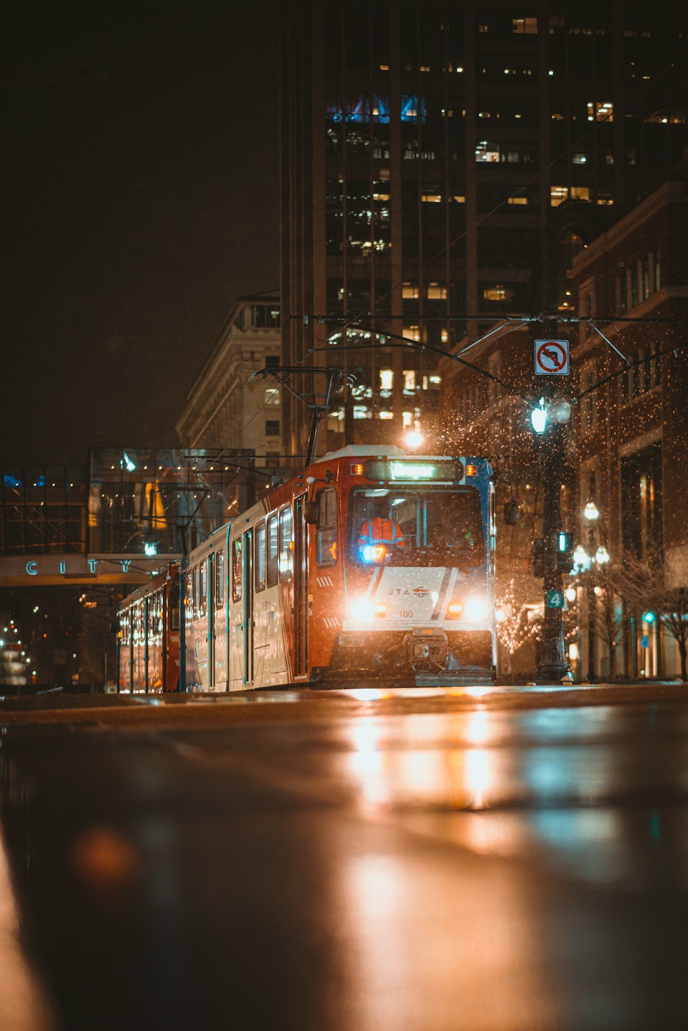 a city bus driving down a street at night