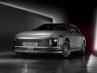 a silver car parked in a dark room