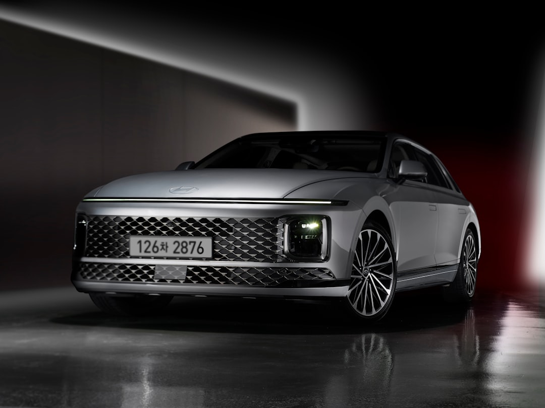 a silver car parked in a dark room, The modern and elegant Hyundai Grandeur