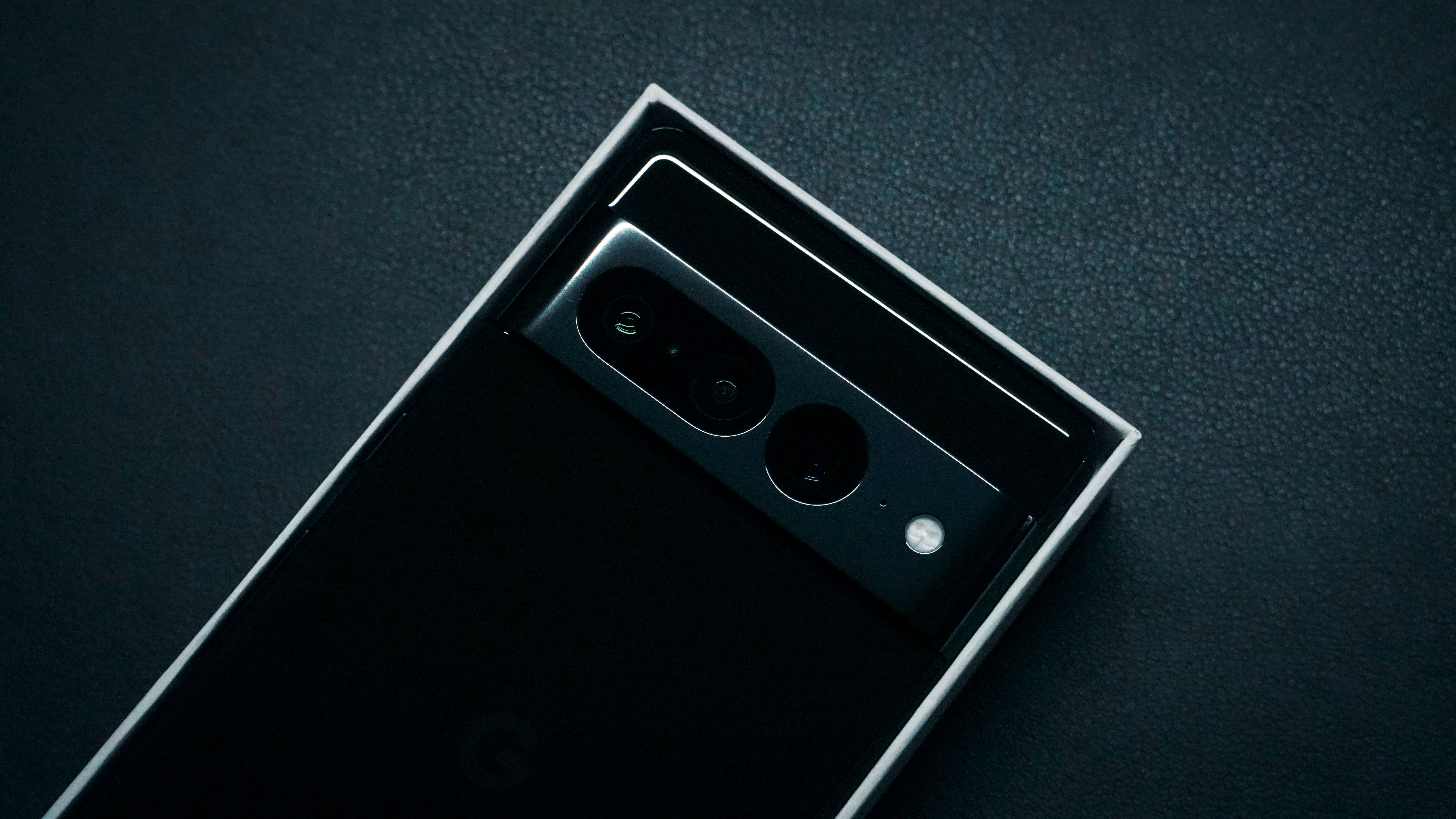 a close up of a cell phone on a black surface