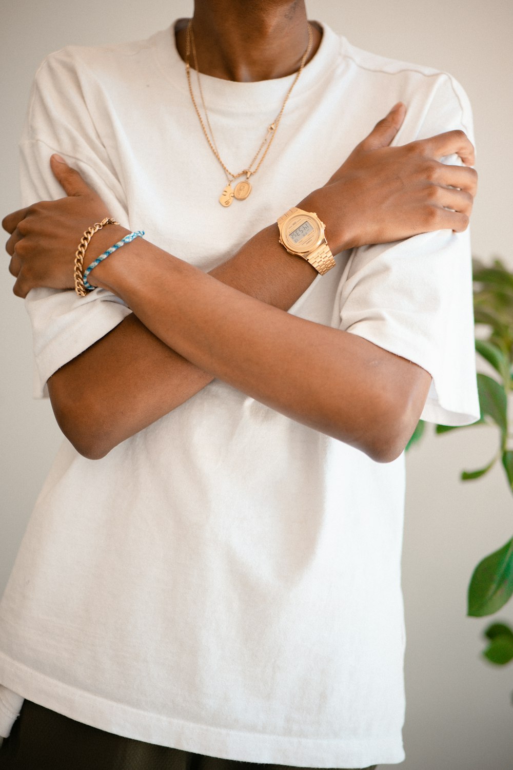 a woman wearing a white shirt and a gold watch