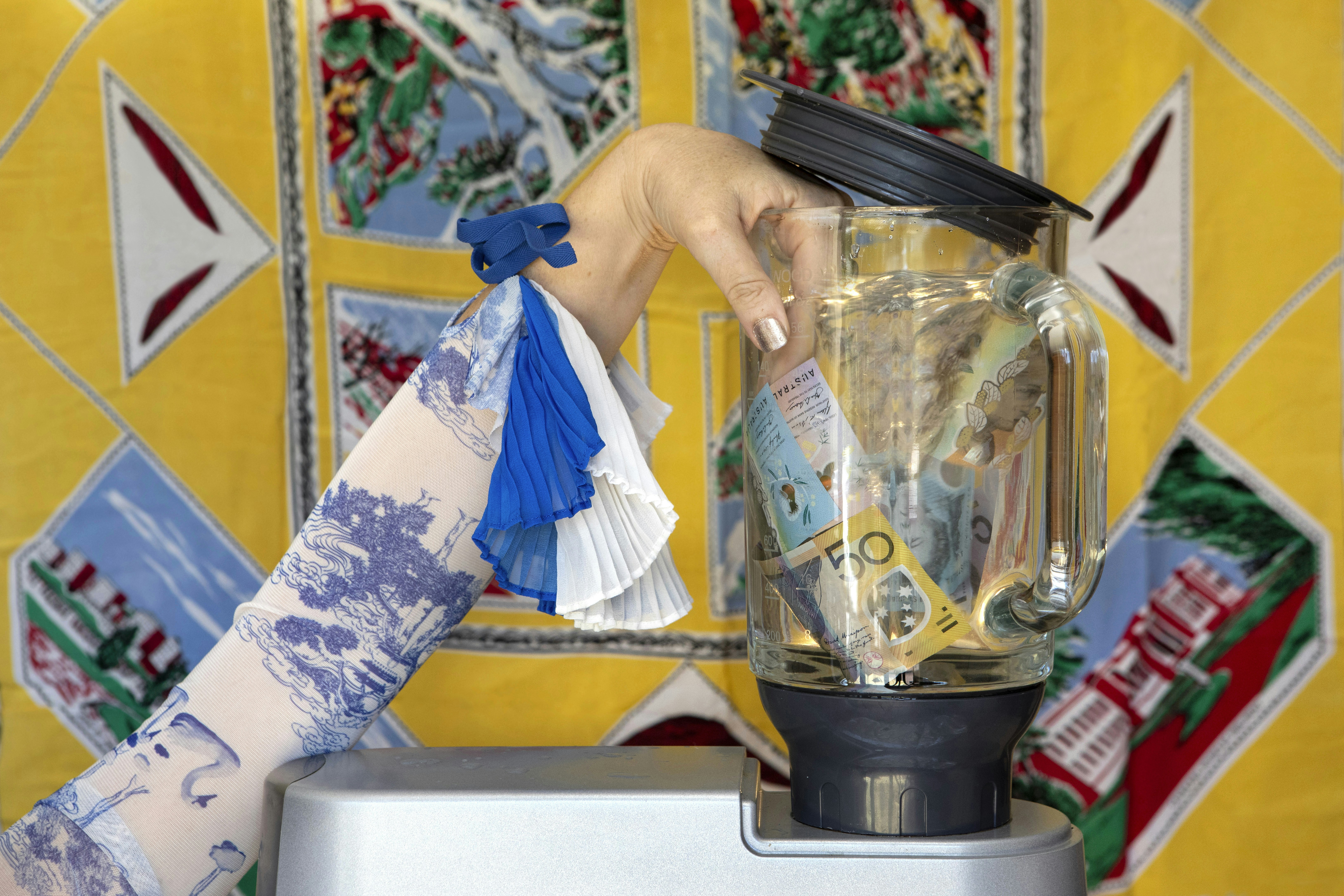 a person putting money into a blender