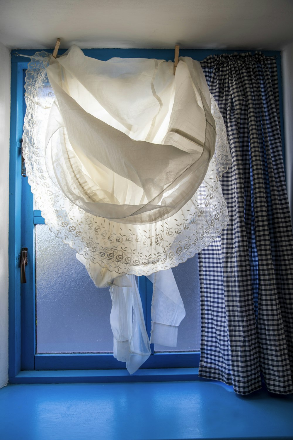 a white dress is hanging on a clothes line