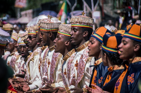 a group of men and women dressed in ethnic garb