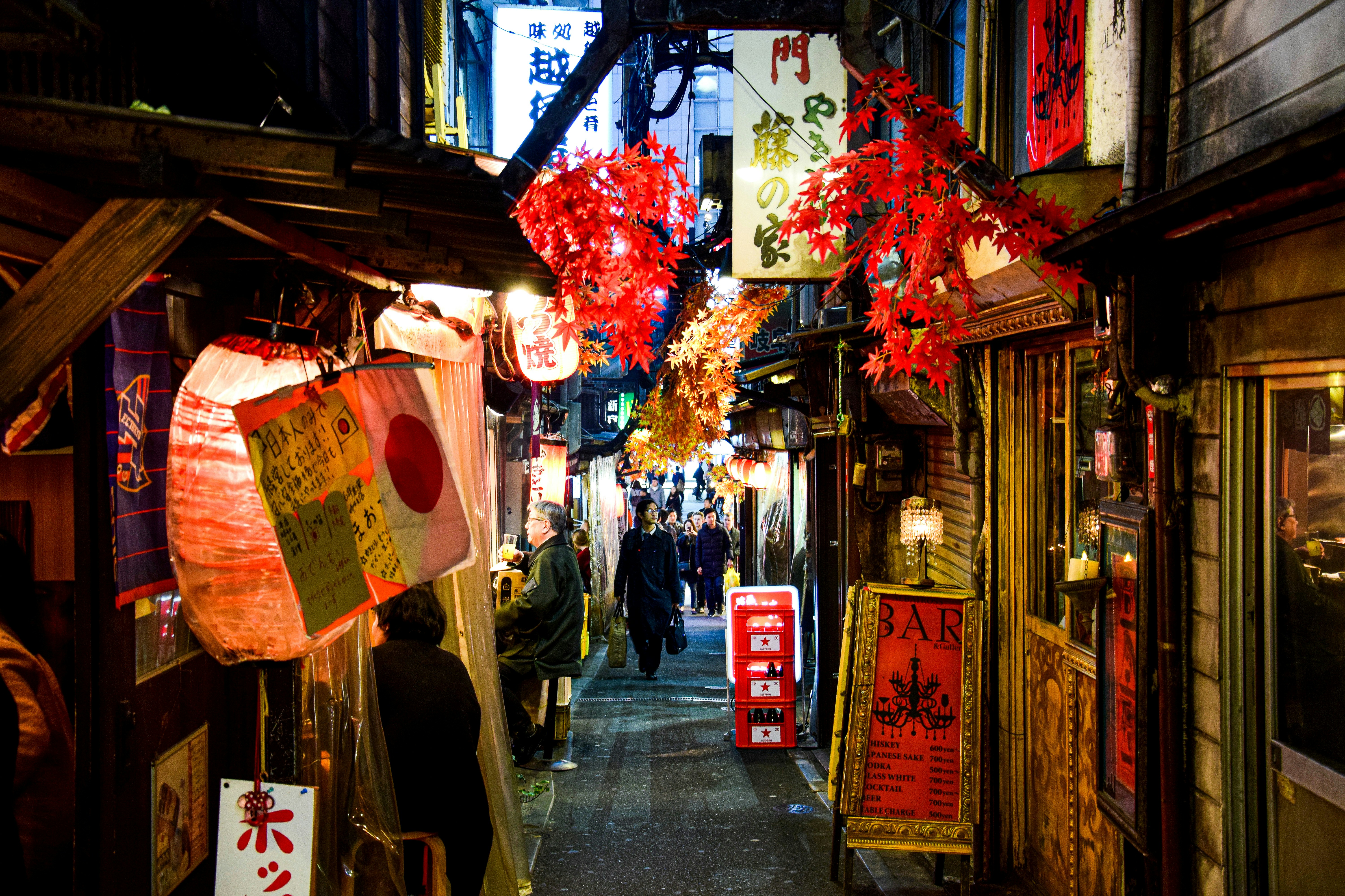 A narrow alley with lanterns hanging from the ceiling photo – Free ...