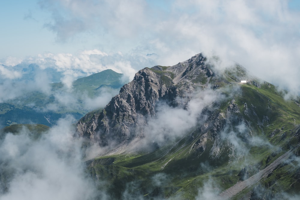 a view of the top of a mountain in the clouds