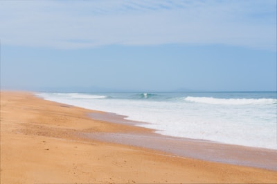 A serene beach with golden sand and gentle waves.