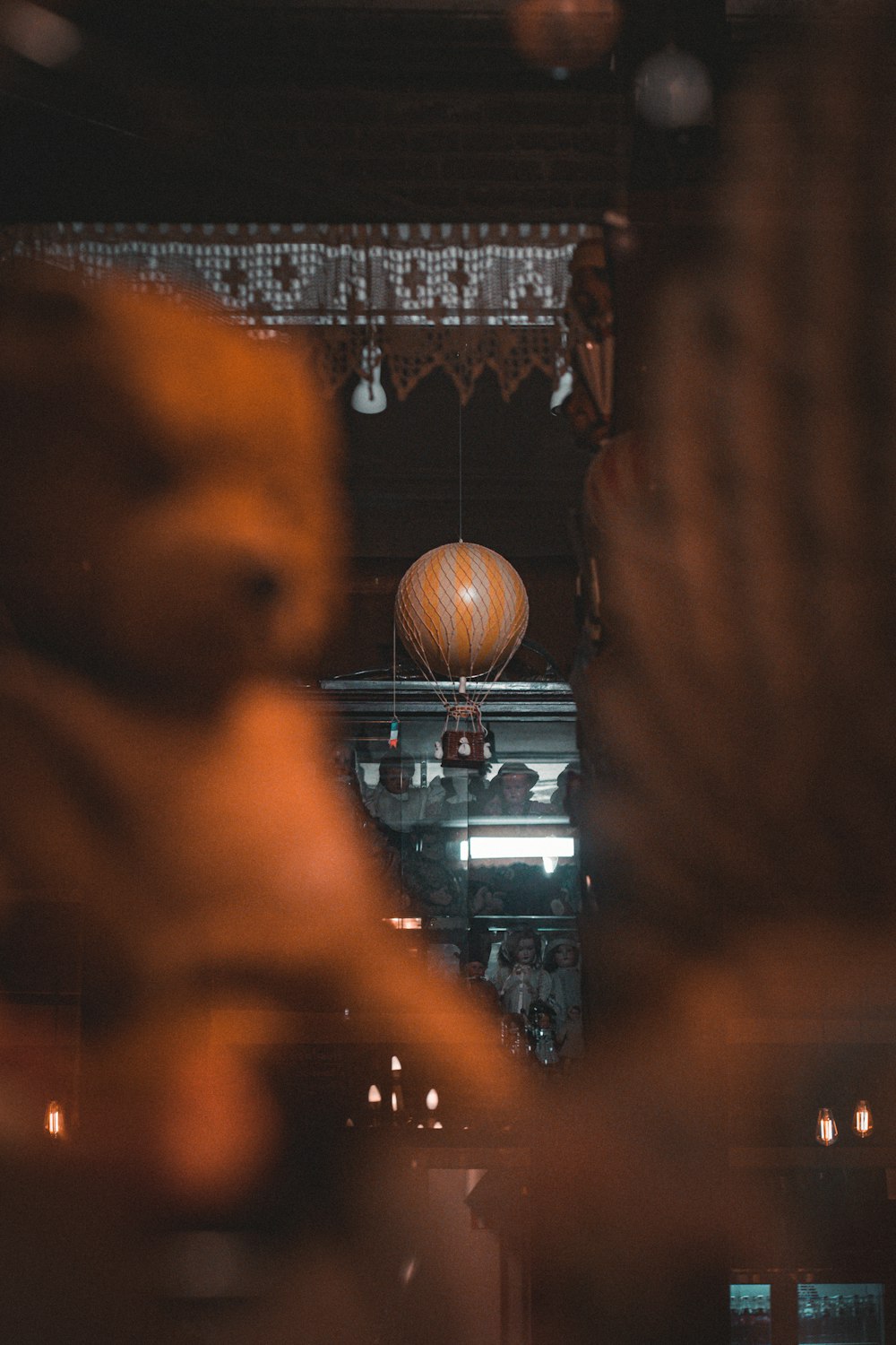 a woman looking at a teddy bear in a store window