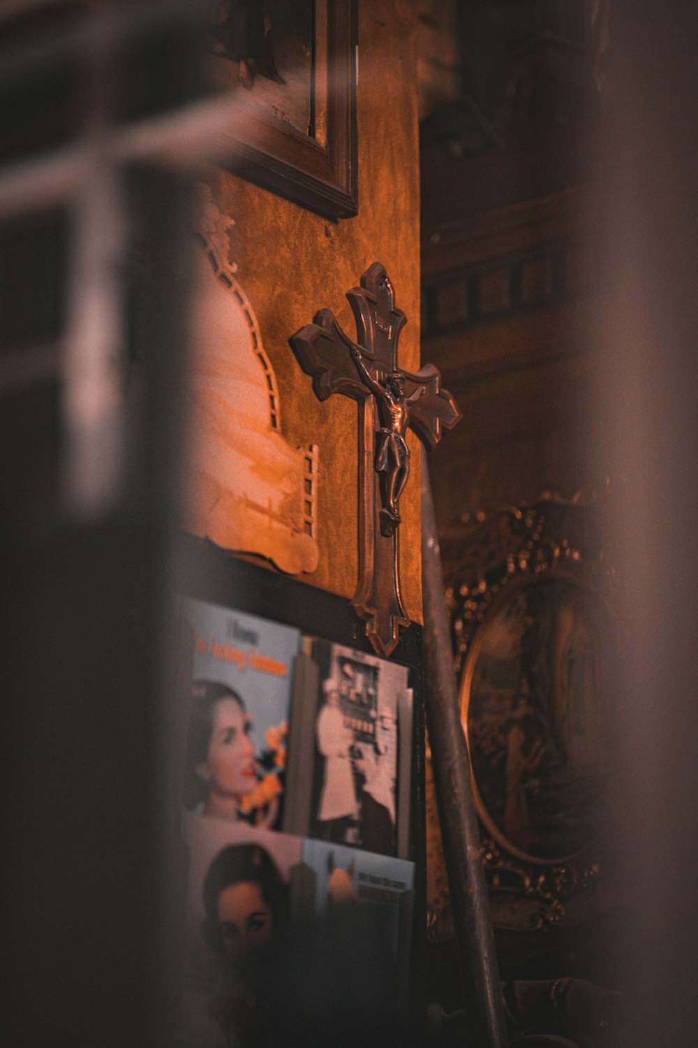 a cross on a wall next to a mirror