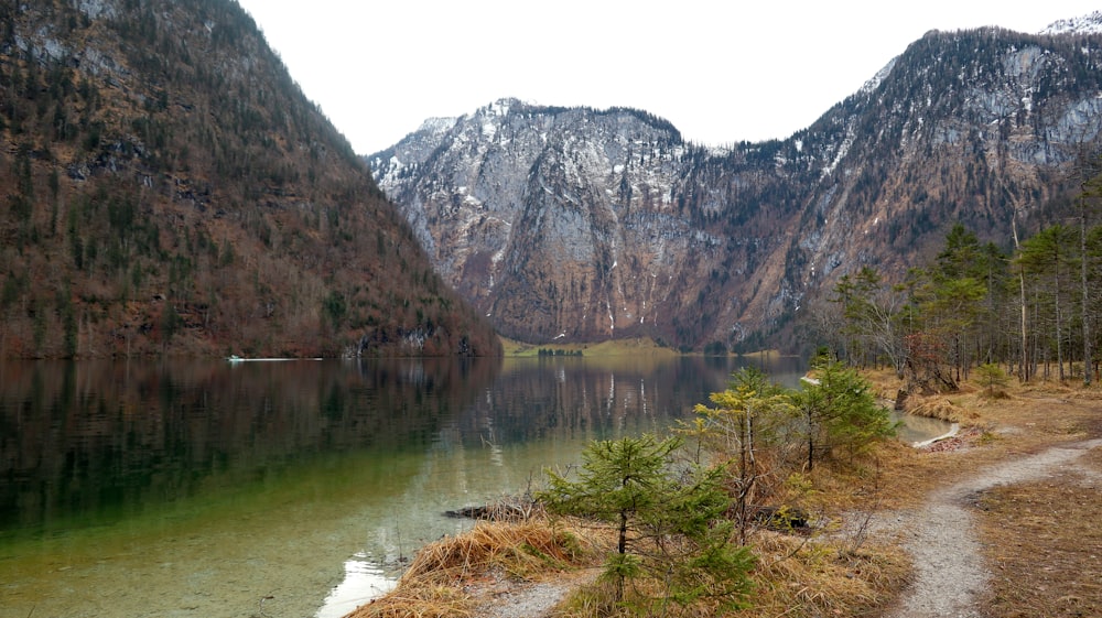 a scenic view of a lake surrounded by mountains