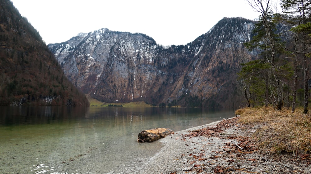 a body of water with mountains in the background