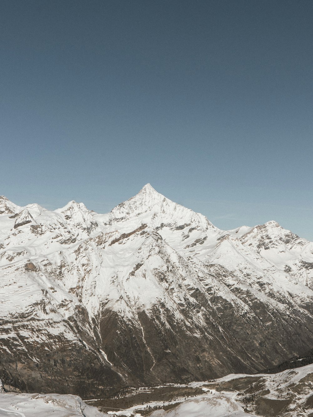 a man riding skis on top of a snow covered slope