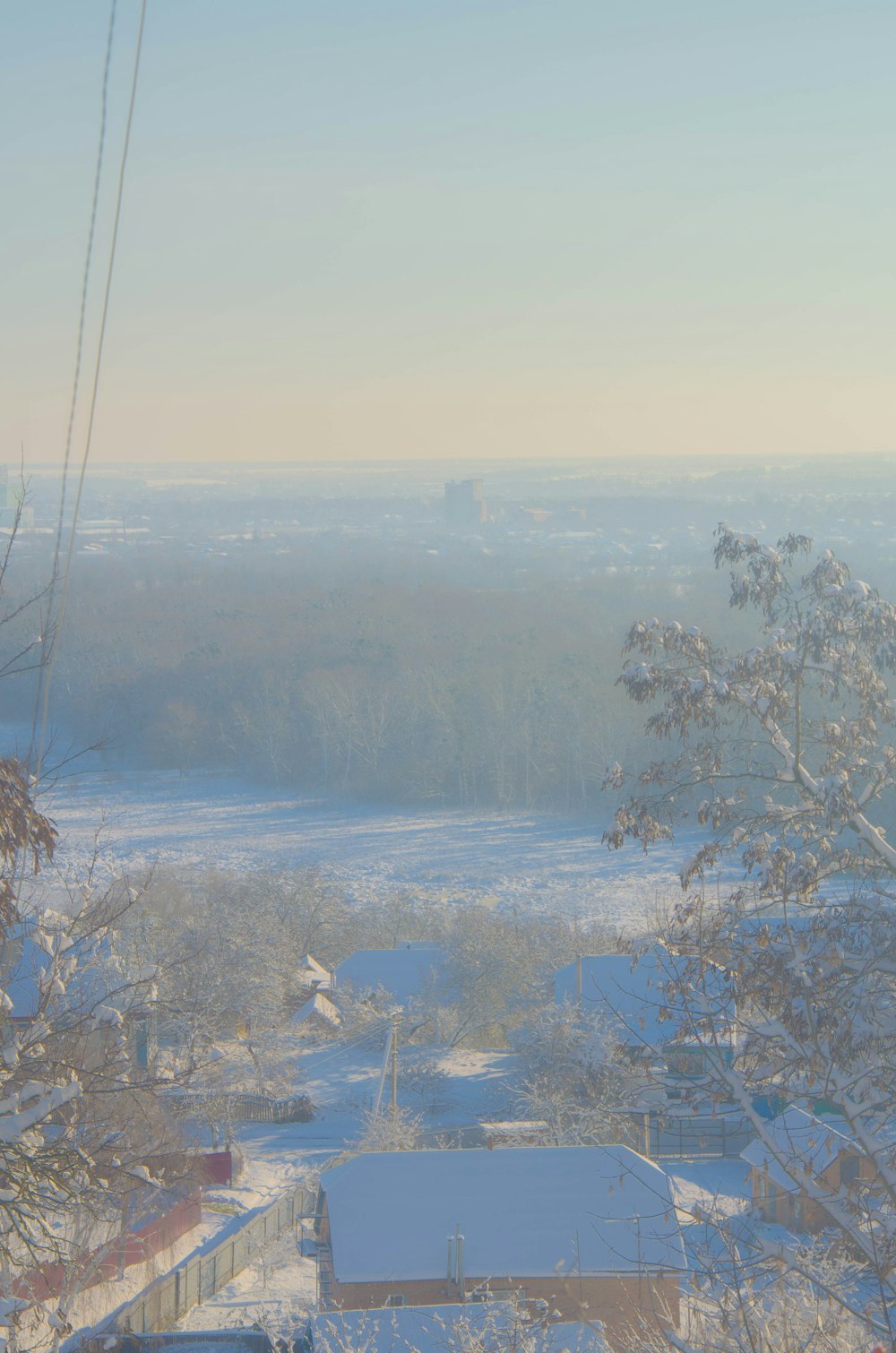 a view of a snowy city from a hill