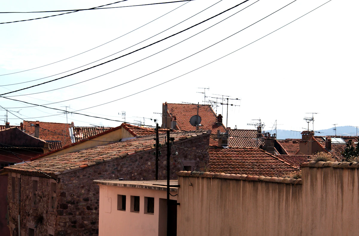 Old tiled roofs in Fréjus, with hills on the skyline
