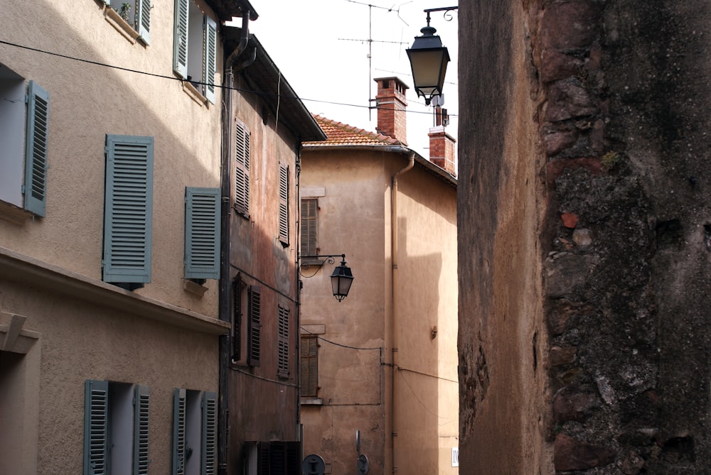 a narrow alley way with a lamp post and windows