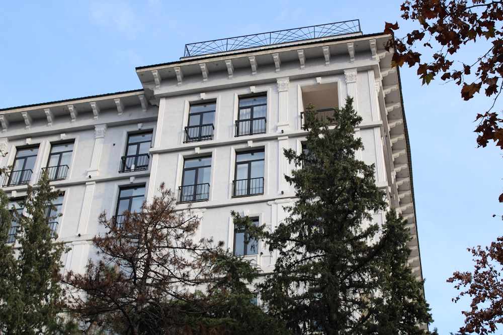 a tall white building with lots of windows