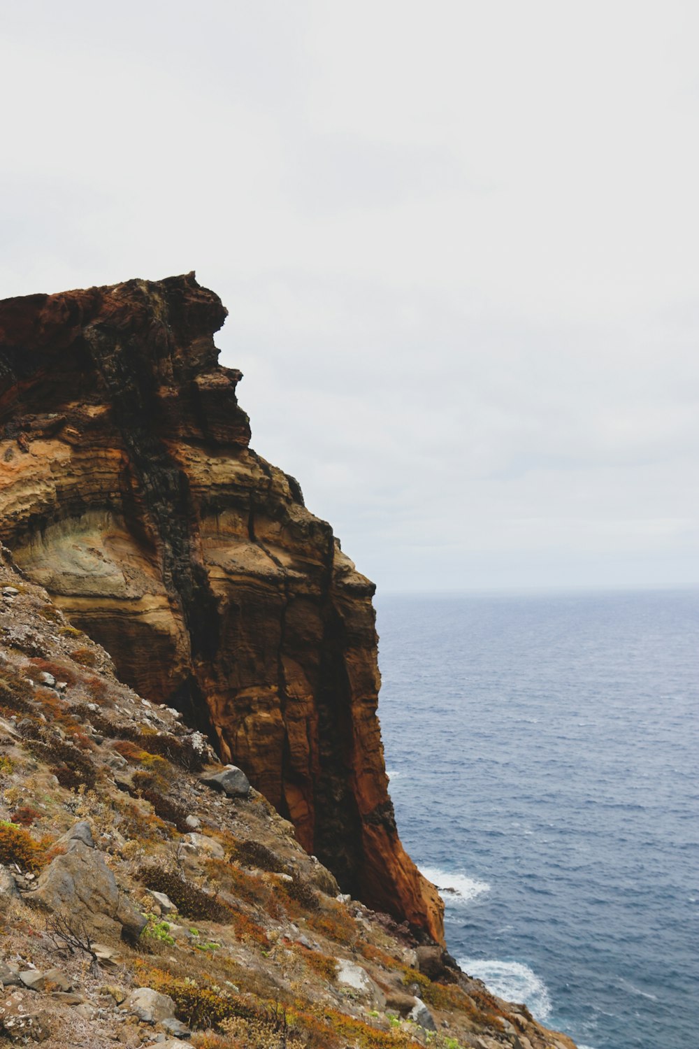 a person standing on a cliff overlooking the ocean