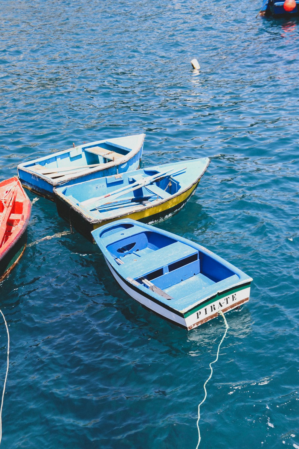 a group of small boats floating on top of a body of water
