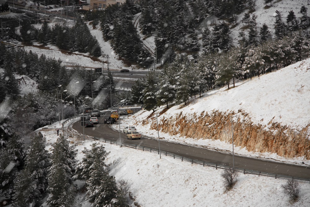 a snow covered road with a truck driving on it