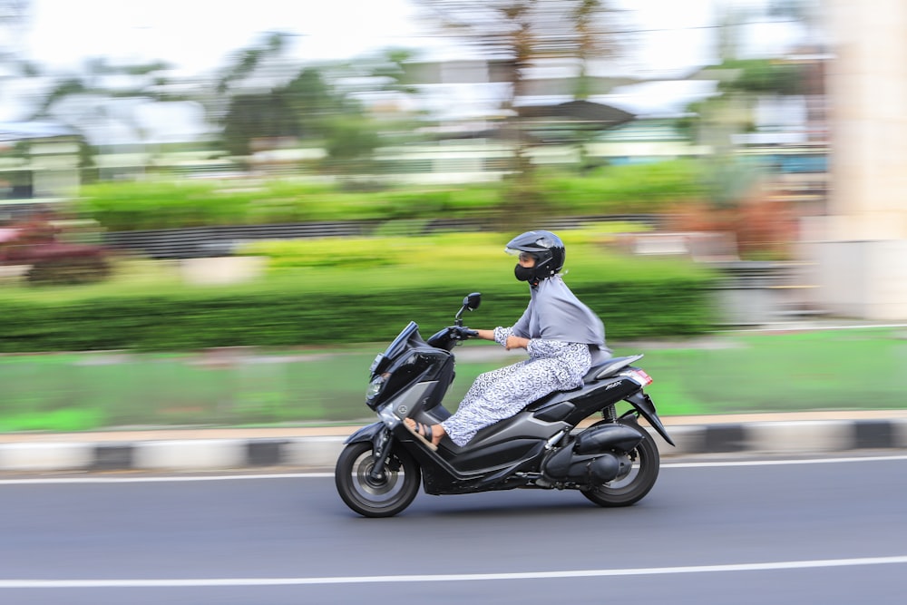 a person riding a motorcycle on a city street