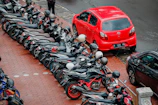 A lineup of motorcycles and cars ready for dispatch at a Riyadh Rápido facility.