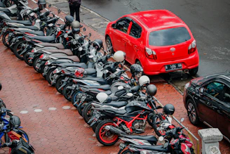 A diverse lineup of vehicles including a car, motorcycle, and truck parked side by side.