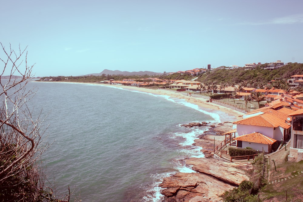 a view of a beach with houses on the shore