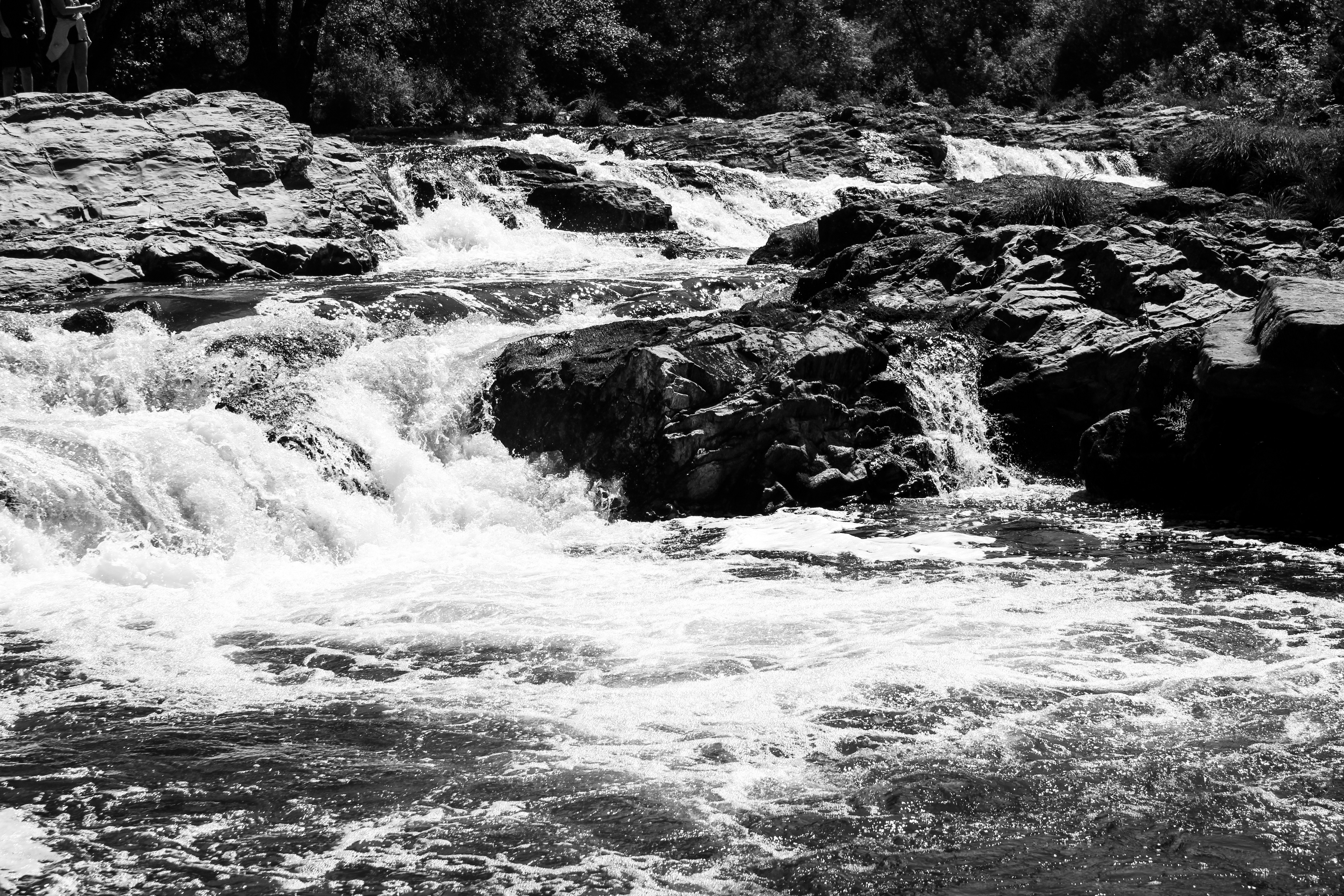 a black and white photo of a waterfall