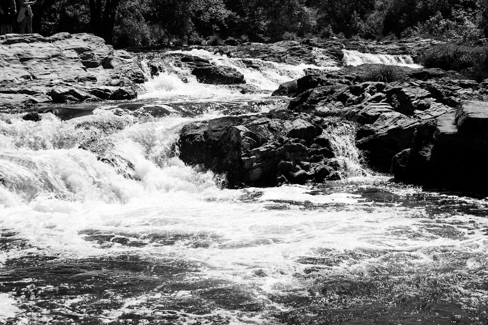 a black and white photo of a waterfall