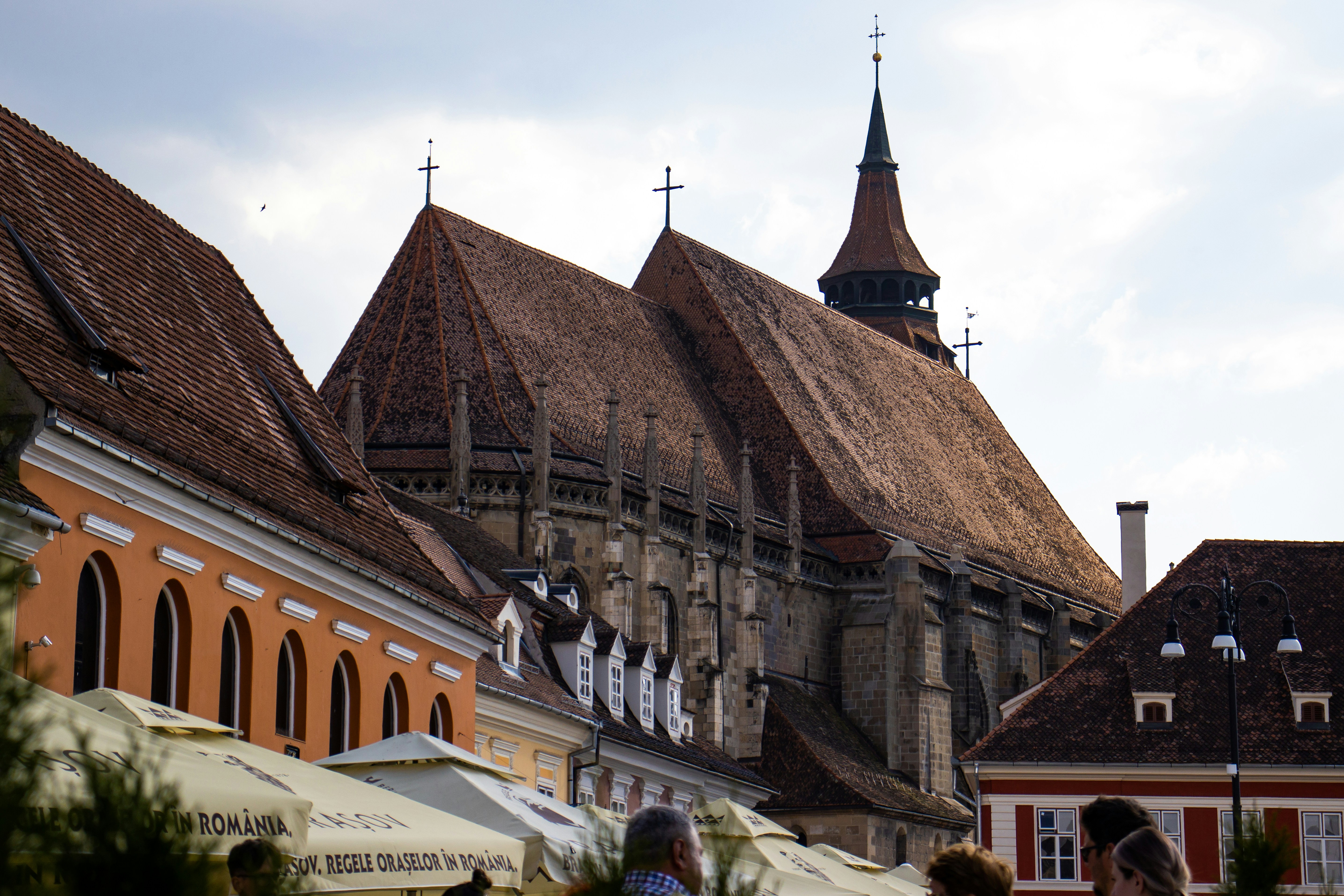 a group of people walking down a street next to tall buildings