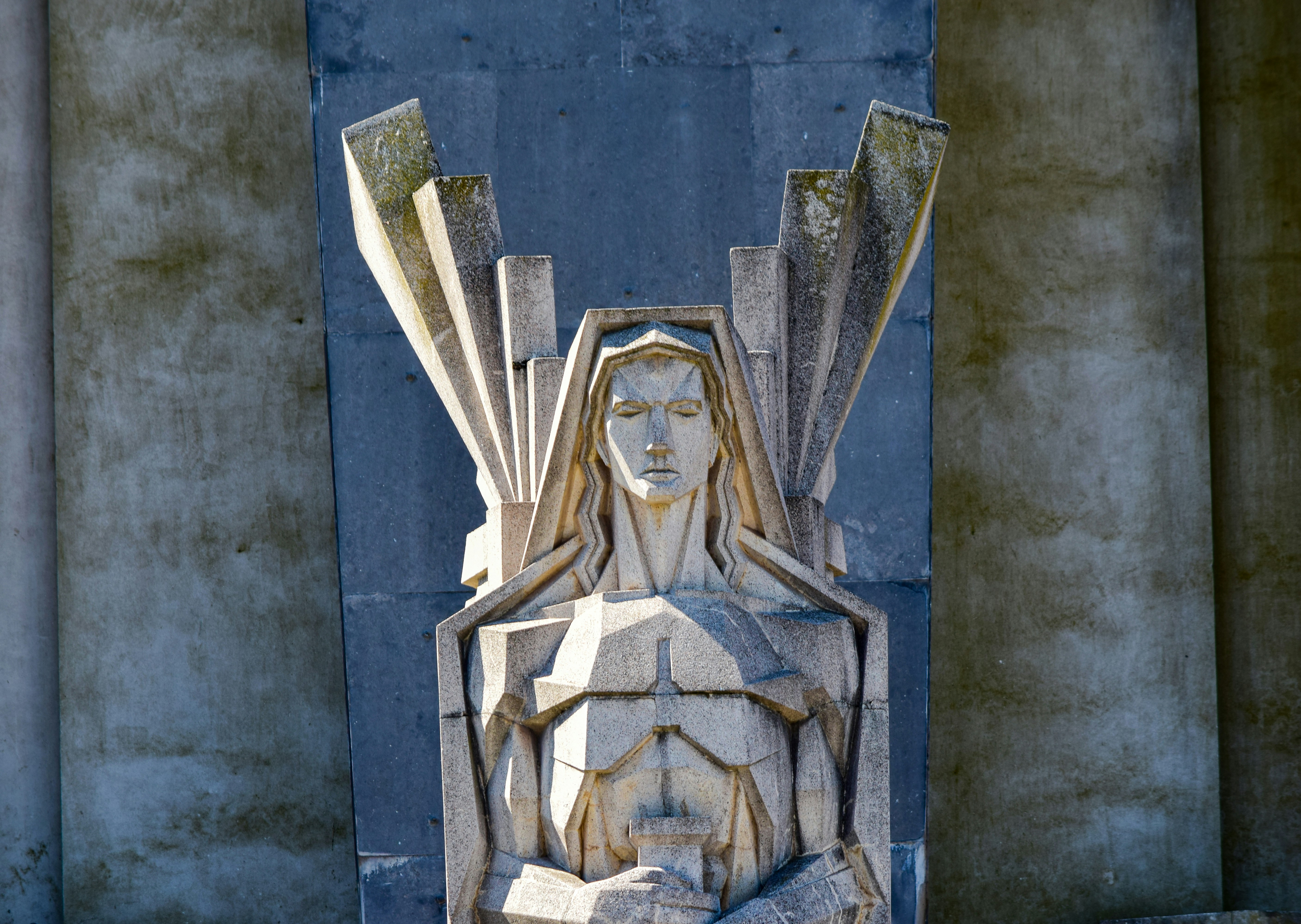 a statue of a woman with wings on her head