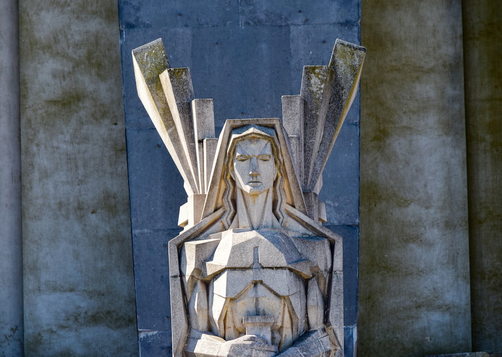 a statue of a woman with wings on her head