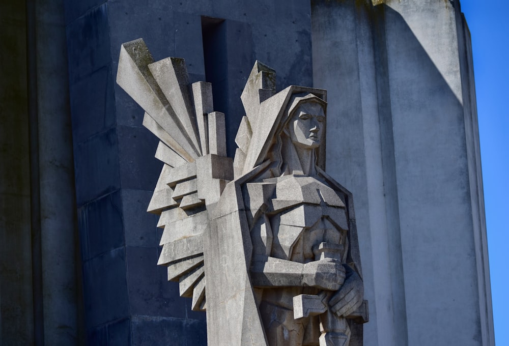 a statue of a person holding a cross