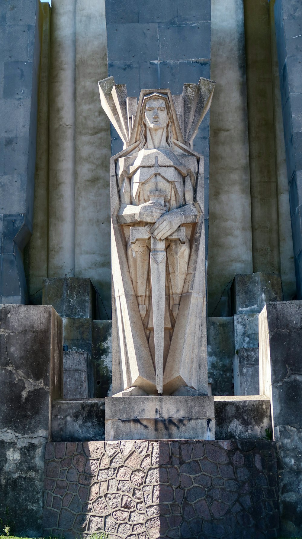 a statue of a man in front of a building