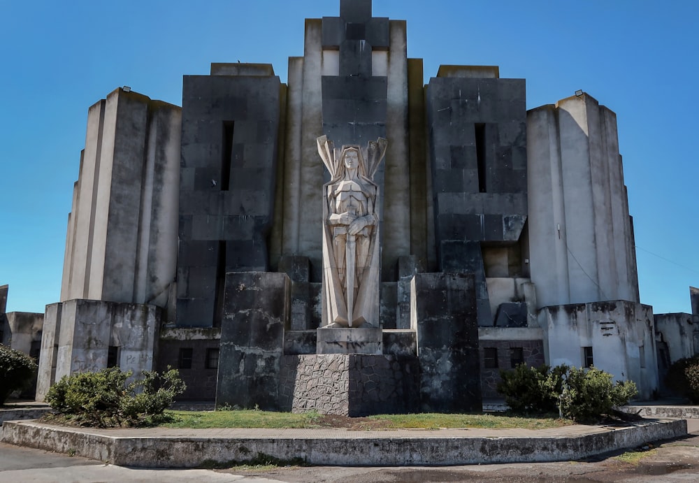 a large building with a statue in front of it