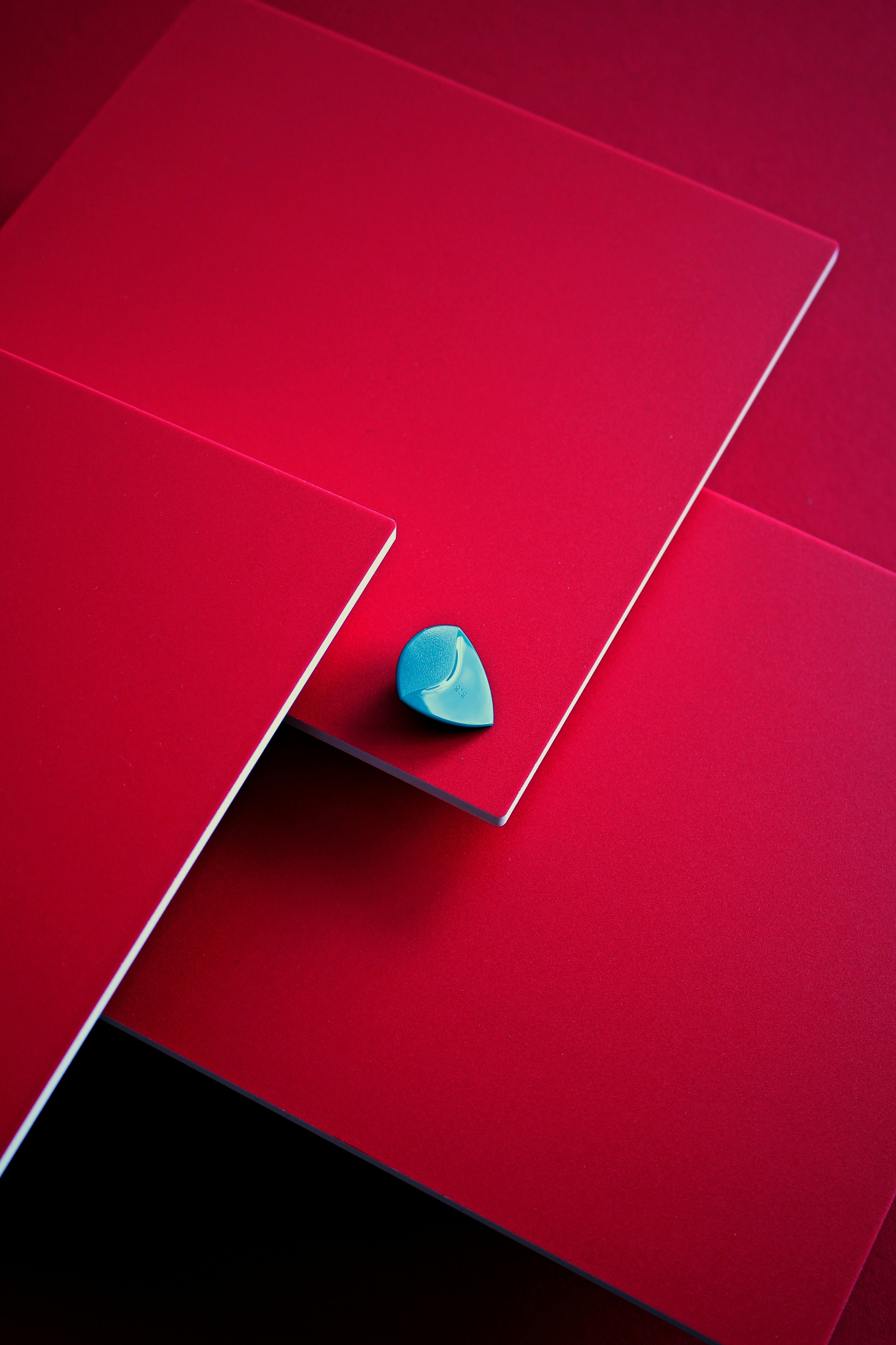 a close up of a red surface with a blue object on it