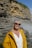 a woman wearing a yellow jacket and sunglasses