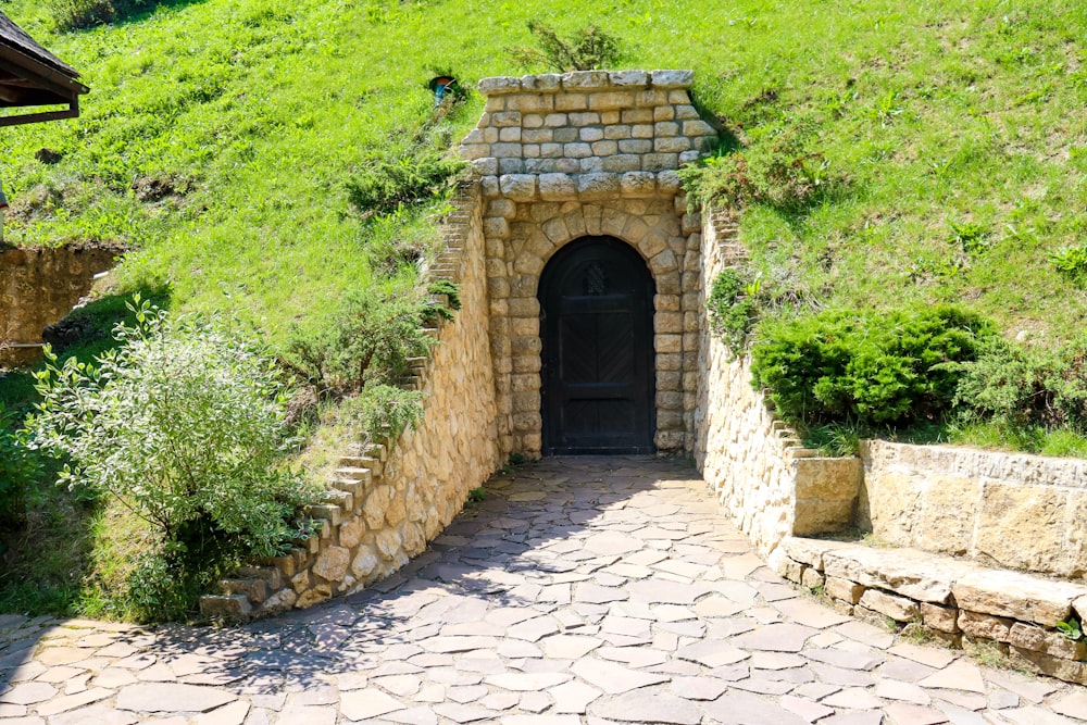 a stone tunnel with a door in the middle of it