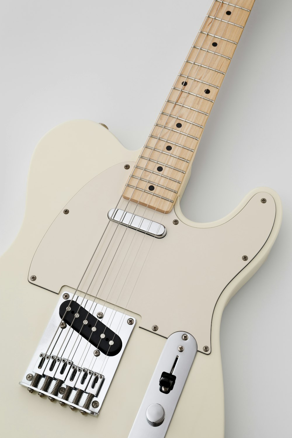 an electric guitar with a white body and neck